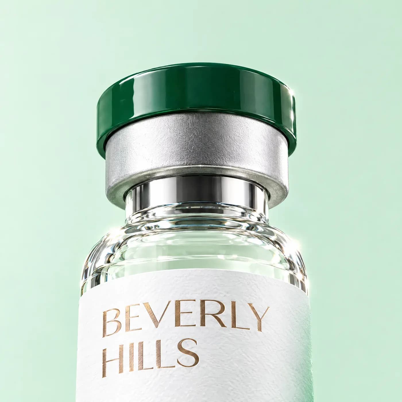 Low-angle close-up of a Beverly Hills Wellness Center vial's green cap
